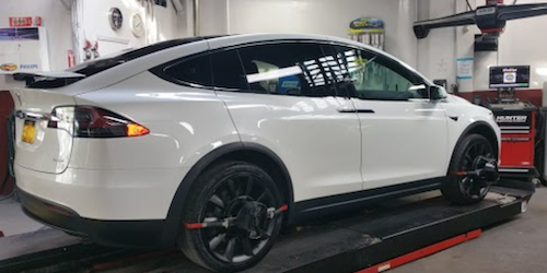 Tesla electric vehicle in the shop for Hunter Wheel Alignment service at Precision Auto Works 11101.